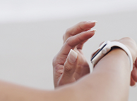 Hand checking time on wristwatch